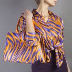 bag in silk and leather with orange pattern worn